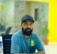 man-in-blue-crew-neck-t-shirt-wearing-black-cap-sitting-on-chair.jpg man in blue crew neck t-shirt wearing black cap sitting on chair